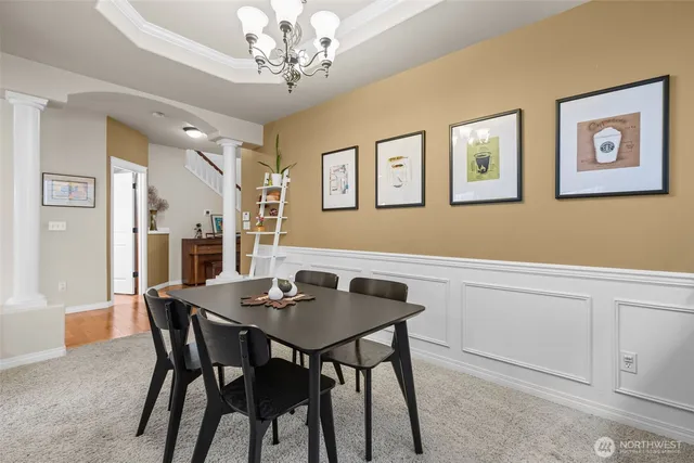 a view of a dining room with furniture and chandelier