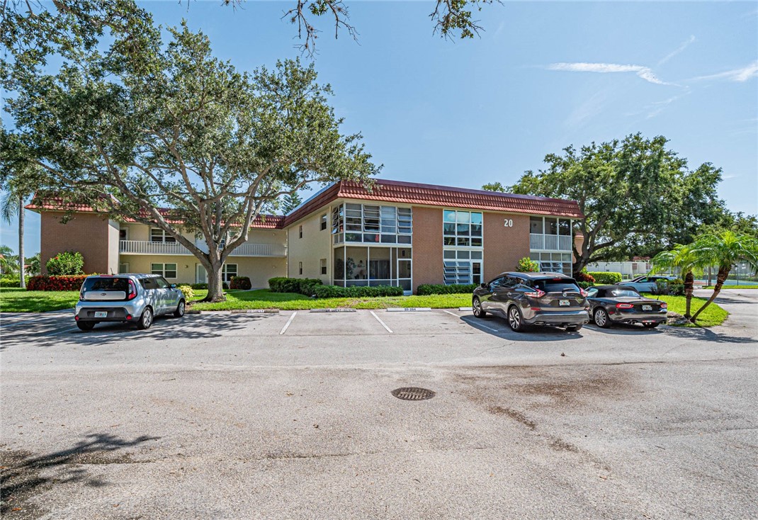 20 Pine Arbor Lane, Unit 202 Vero Beach, FL 32962 - Photo 1 of 36 a view of a house with a large space and a parked car