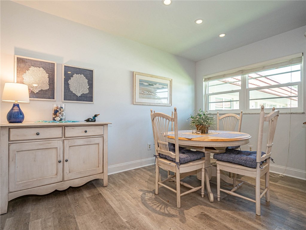 20 Pine Arbor Lane, Unit 202 Vero Beach, FL 32962 - Photo 14 of 36 a view of a dining room with furniture and wooden floor