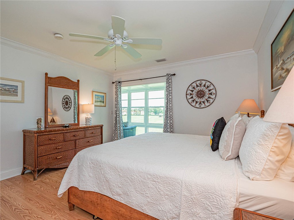 20 Pine Arbor Lane, Unit 202 Vero Beach, FL 32962 - Photo 16 of 36 a bedroom with a bed and a chandelier