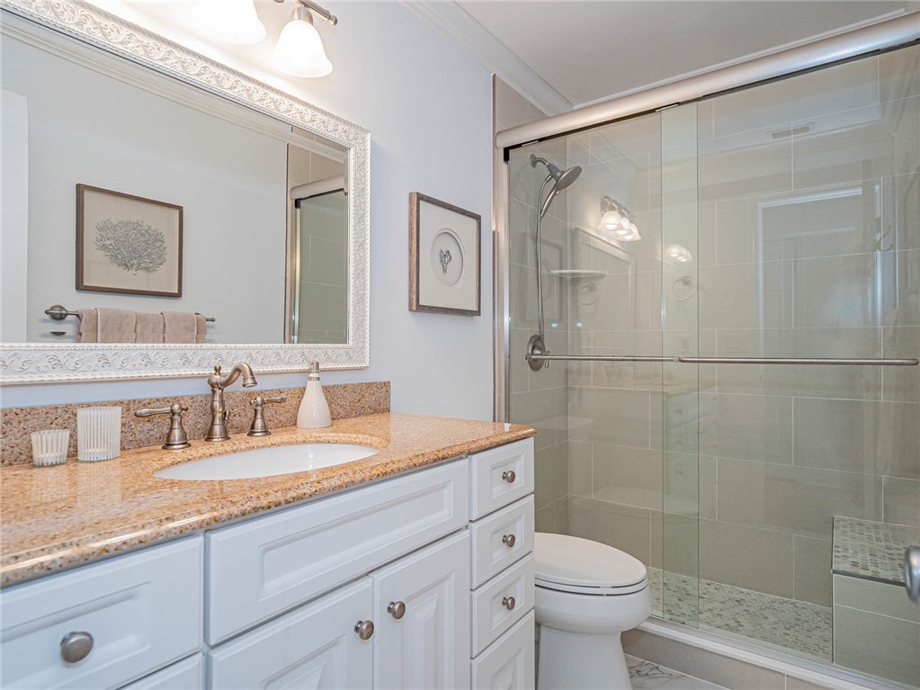 20 Pine Arbor Lane, Unit 202 Vero Beach, FL 32962 - Photo 23 of 36 a bathroom with a double vanity sink mirror and toilet