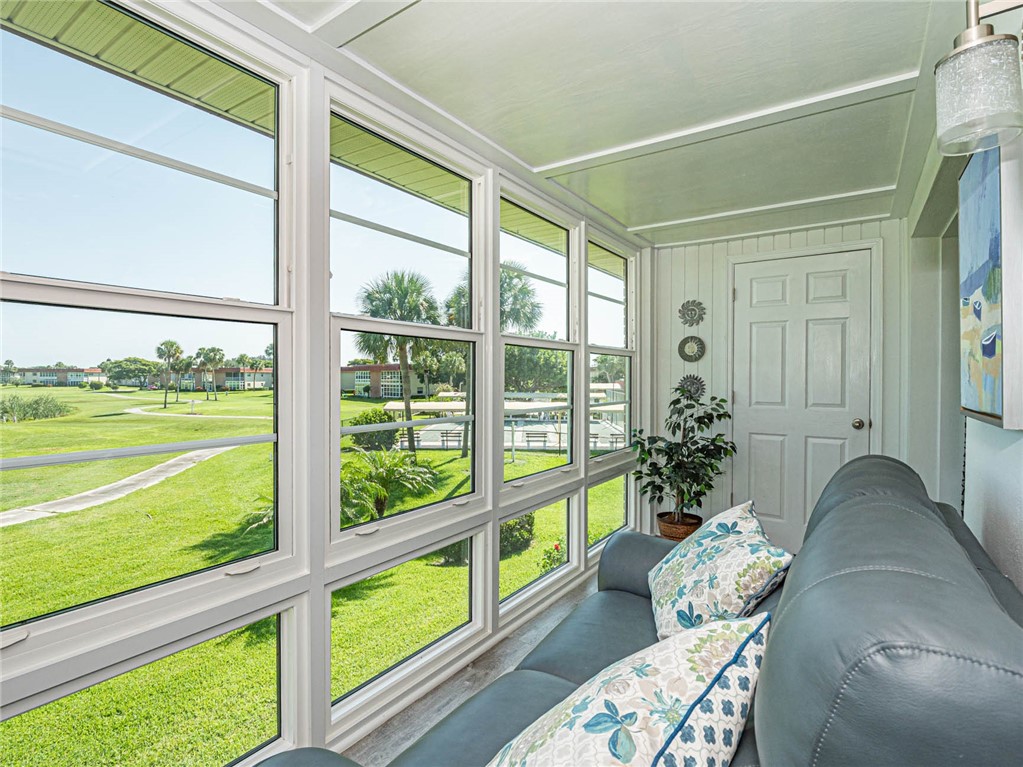 20 Pine Arbor Lane, Unit 202 Vero Beach, FL 32962 - Photo 26 of 36 a living room filled with furniture and a large window