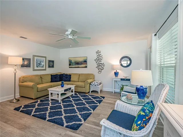 a living room with furniture a rug and a large window