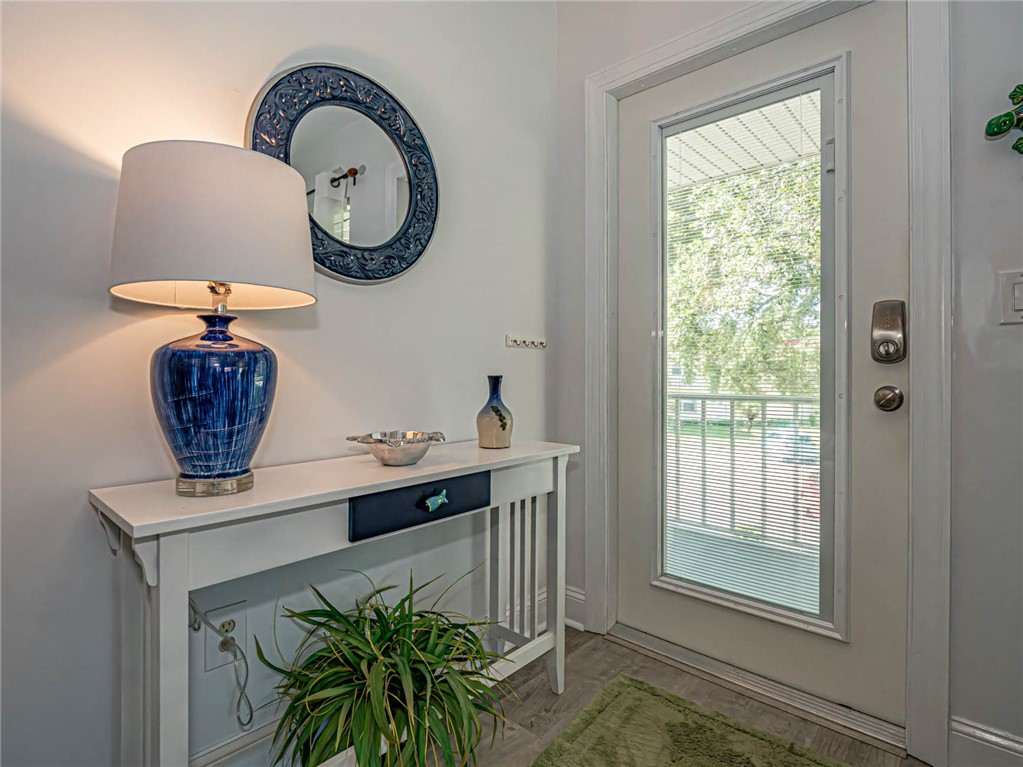20 Pine Arbor Lane, Unit 202 Vero Beach, FL 32962 - Photo 6 of 36 a vase of flowers sitting on a table near a window