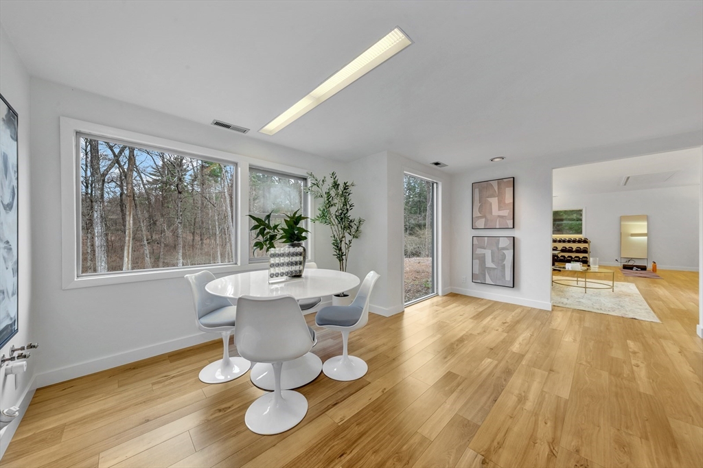 85 The Valley Road Concord, MA 01742 - Photo 33 of 38 a dining room with wooden floor and large windows