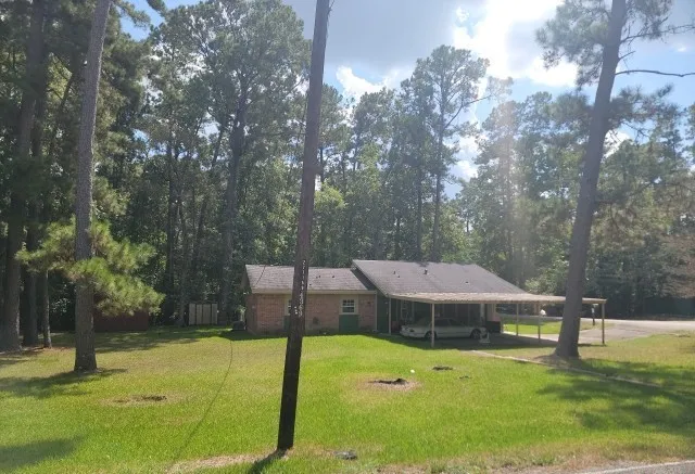 a view of a swimming pool with a patio and a yard