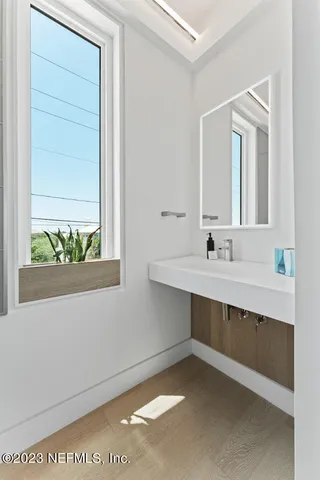a bathroom with a sink a mirror and a bathtub