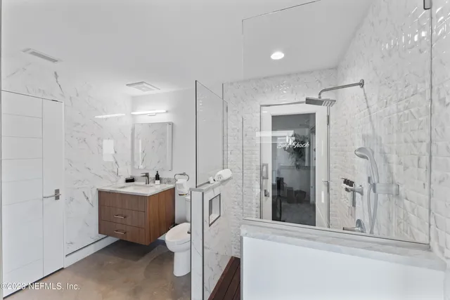 a bathroom with a double vanity sink toilet and shower