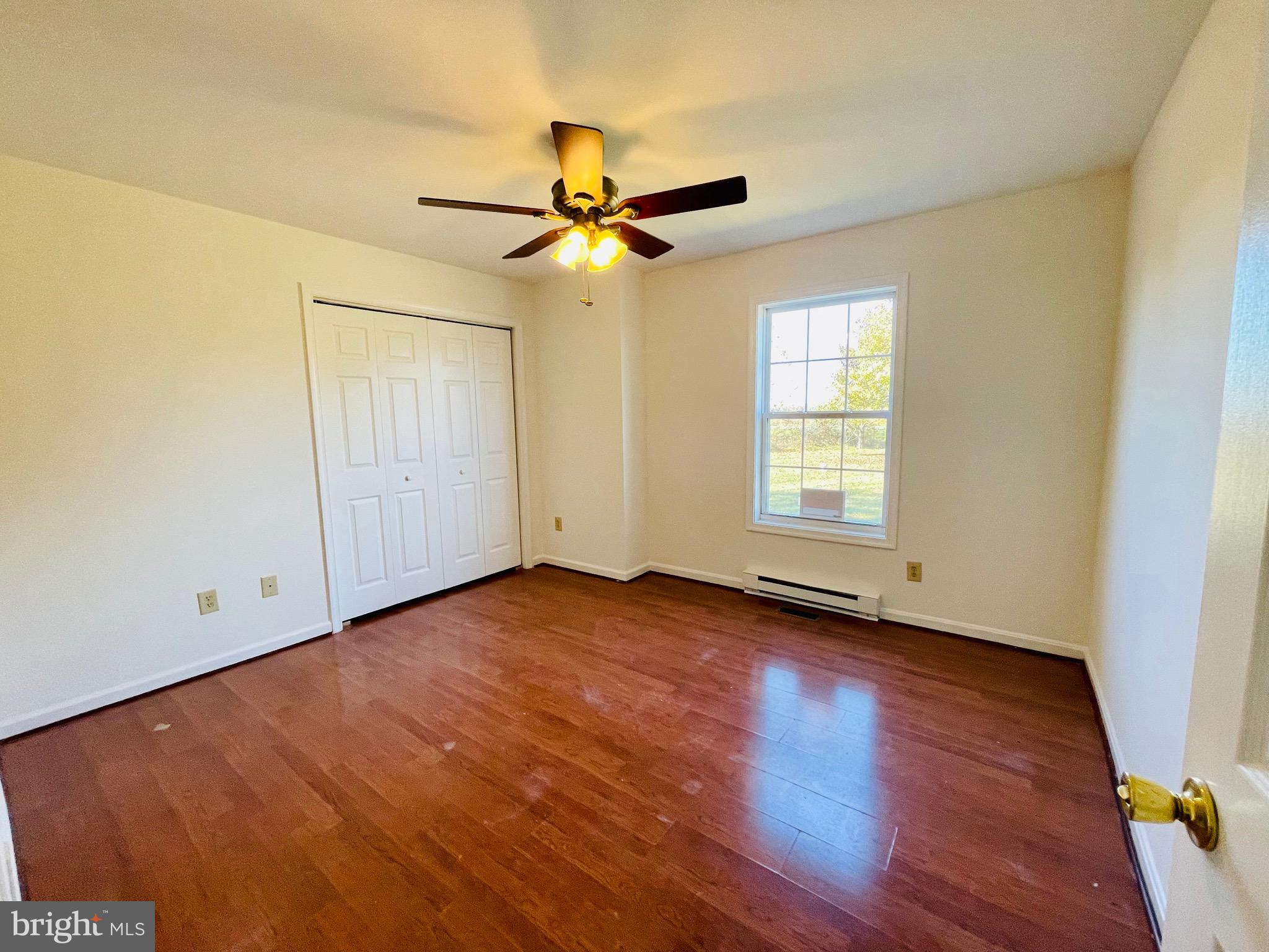 5707 Galestown - Reliance Road Rhodesdale, MD 21659 - Photo 20 of 33 an empty room with wooden floor fan and windows
