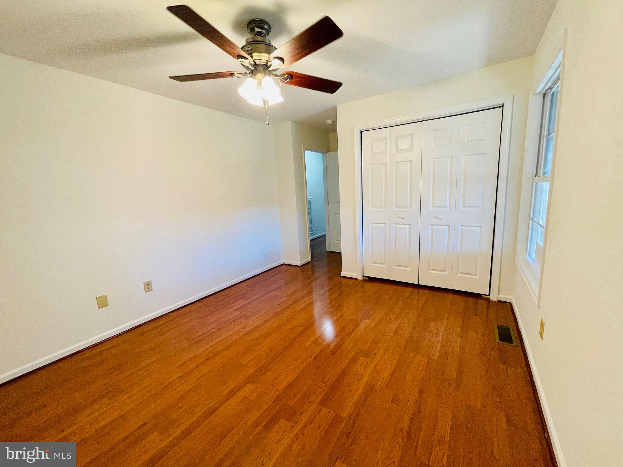 5707 Galestown - Reliance Road Rhodesdale, MD 21659 - Photo 21 of 33 an empty room with wooden floor and fan
