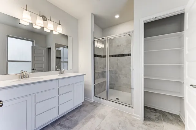 a bathroom with a shower sink and mirror