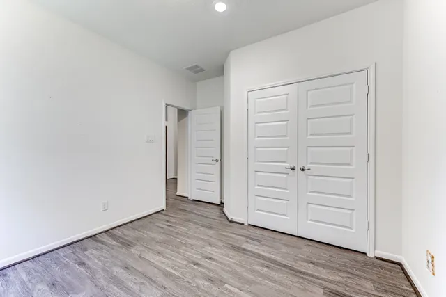 an empty room with wooden floor