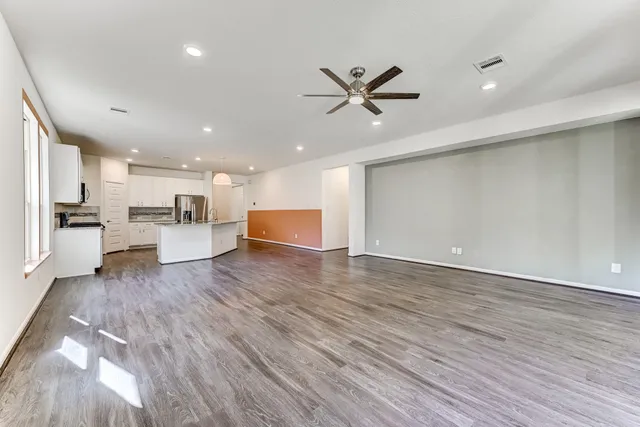 a view of a kitchen with a dishwasher wooden floor and a refrigerator