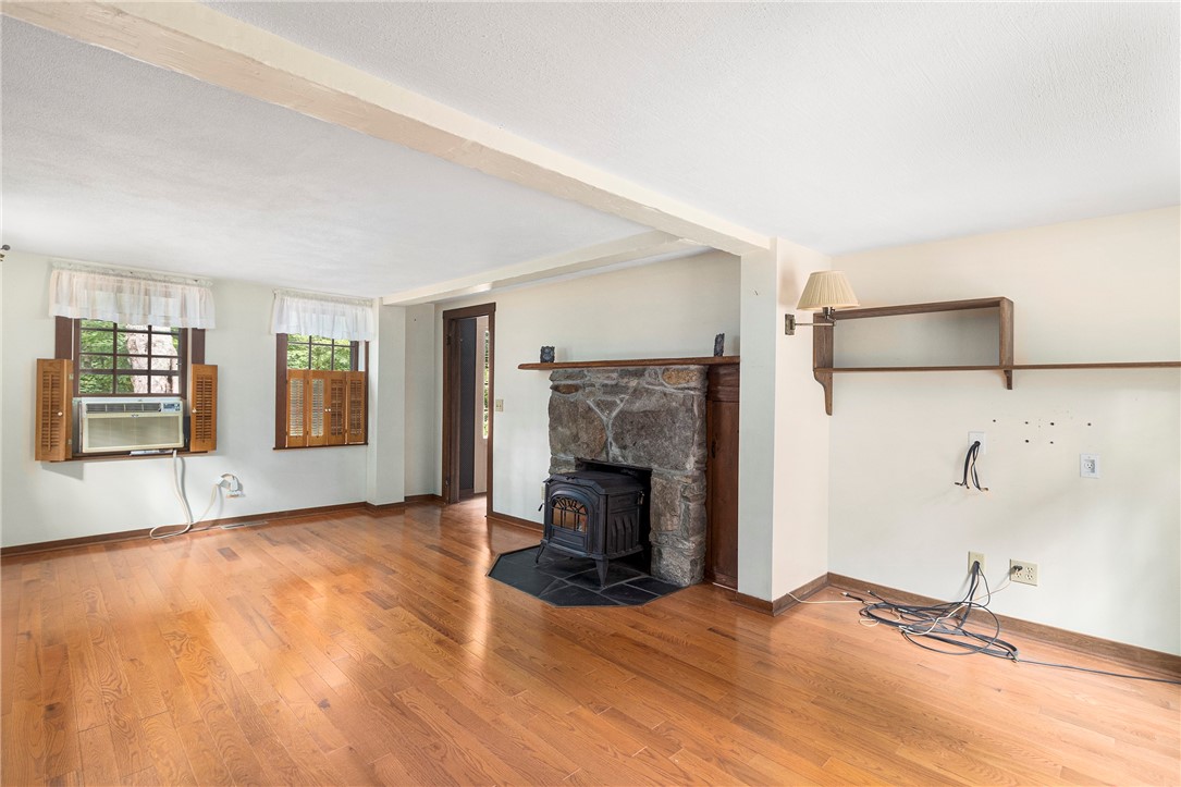 159 Evans Road Glocester, RI 02814 - Photo 3 of 50 Front to back living room with fireplace, woodstove insert and hardwood floors. Plenty of room for 2 sitting areas.