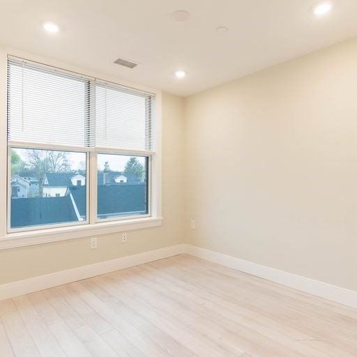 197 Green Street, Unit 305 Boston, MA 02130 - Photo 7 of 7 a view of an empty room with a window