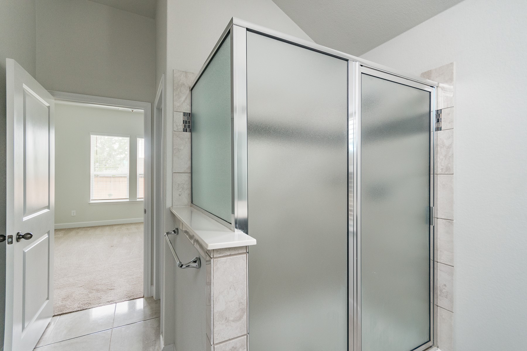 527 Bridgestone Way Buda, TX 78610 - Photo 12 of 21 a bathroom with a shower and a mirror