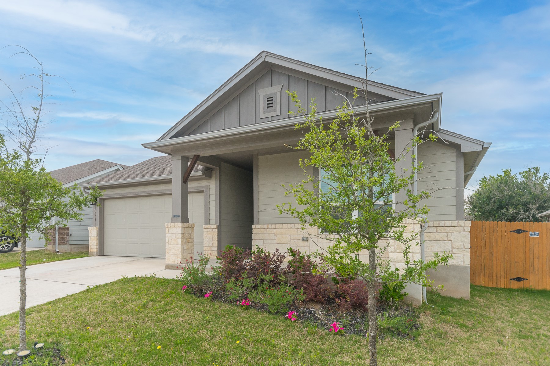 527 Bridgestone Way Buda, TX 78610 - Photo 2 of 21 a front view of a house with garden