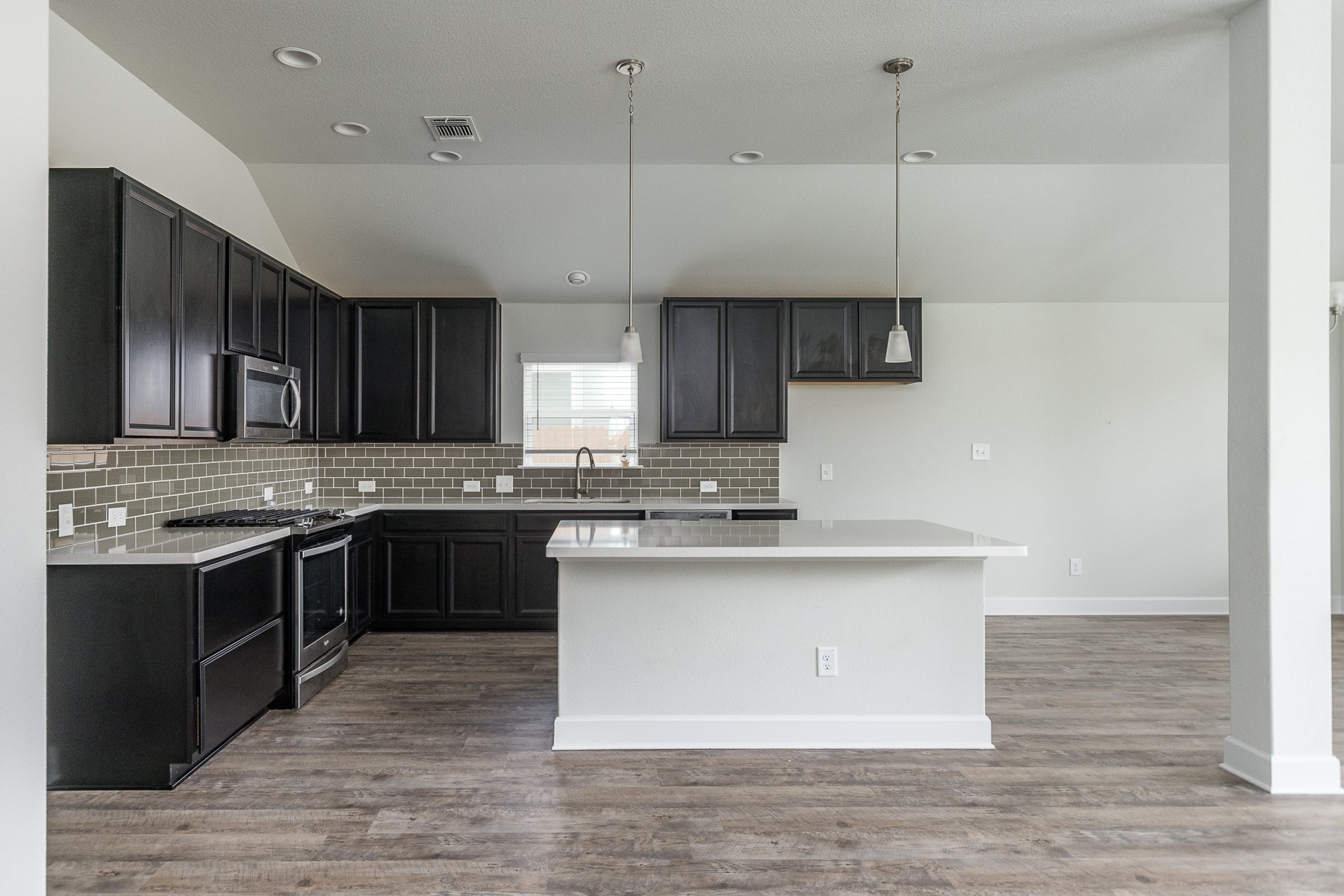 527 Bridgestone Way Buda, TX 78610 - Photo 4 of 21 a kitchen with stainless steel appliances granite countertop a sink a stove and a wooden floors