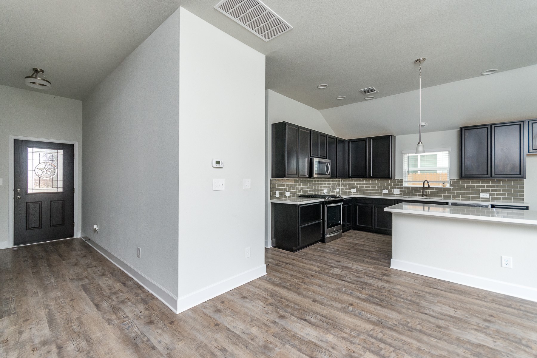 527 Bridgestone Way Buda, TX 78610 - Photo 5 of 21 a large kitchen with a center island and stainless steel appliances