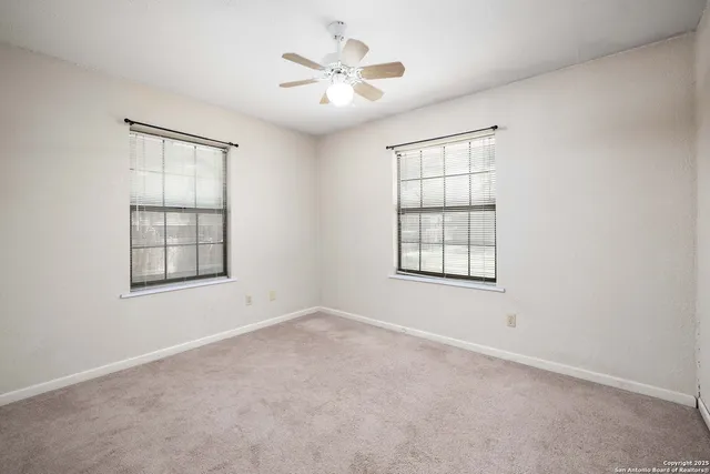 a bathroom with a granite countertop sink a toilet and mirror