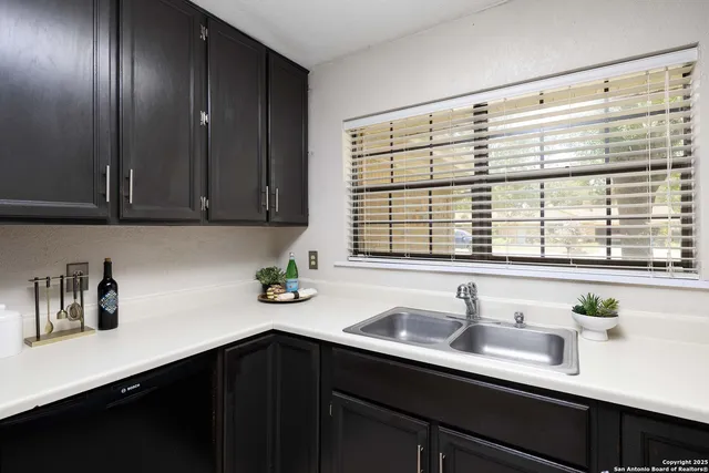 a kitchen with a sink and cabinets