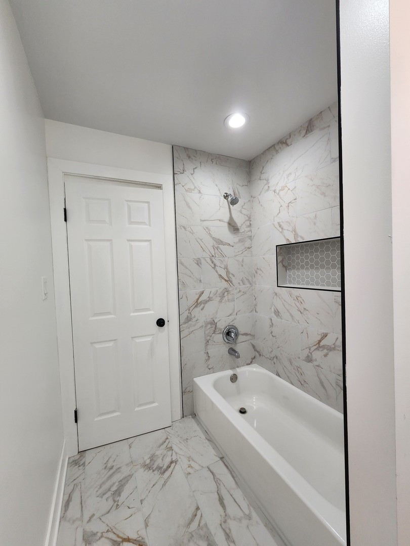 8900 South Normal Avenue, Unit 2 Chicago, IL 60620 - Photo 5 of 7 a bathroom with a bathtub and a shower