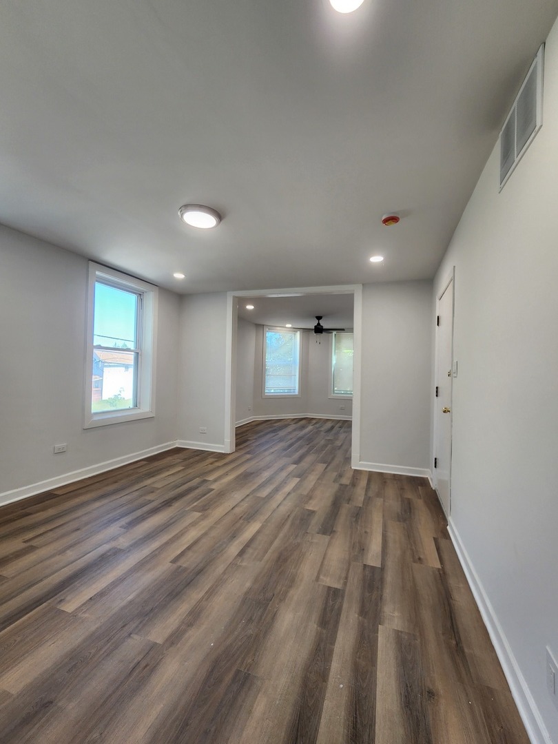8900 South Normal Avenue, Unit 2 Chicago, IL 60620 - Photo 7 of 7 wooden floor in an empty room with a window