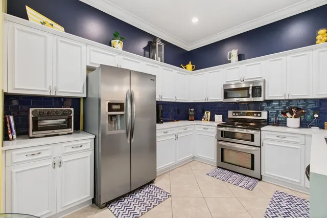 a kitchen with stainless steel appliances a refrigerator a stove a microwave and cabinets