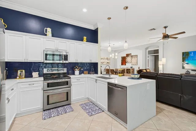 a kitchen with cabinets a sink and white appliances