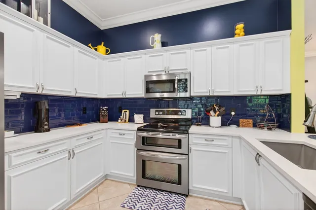 a kitchen with stainless steel appliances granite countertop a sink and a stove