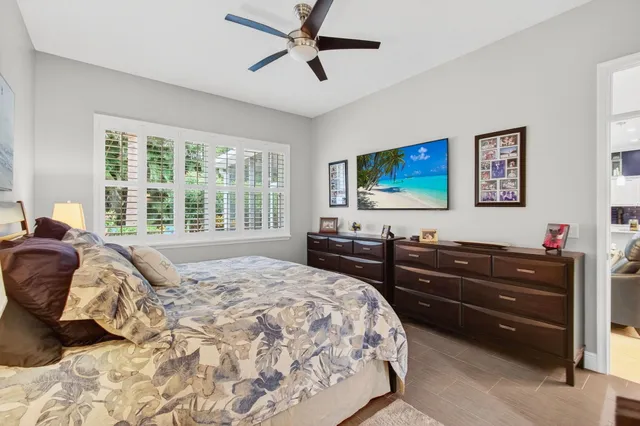 a bedroom with a bed window and dresser