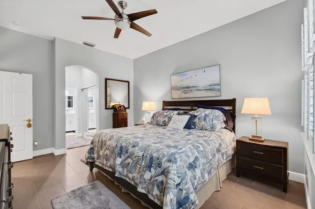 a bedroom with a bed and lamp