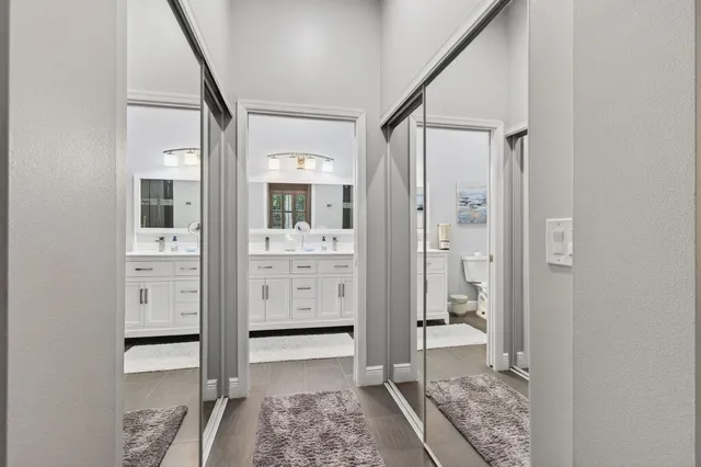 a bathroom with a toilet sink and mirror