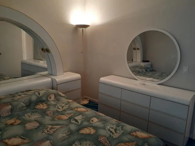 a bathroom with a sink and mirror with toilet