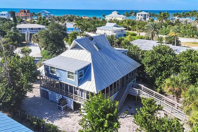 an aerial view of a house with a yard pool outdoor seating and yard