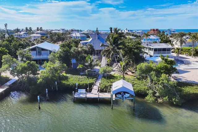 a aerial view of a house with a garden and lake view