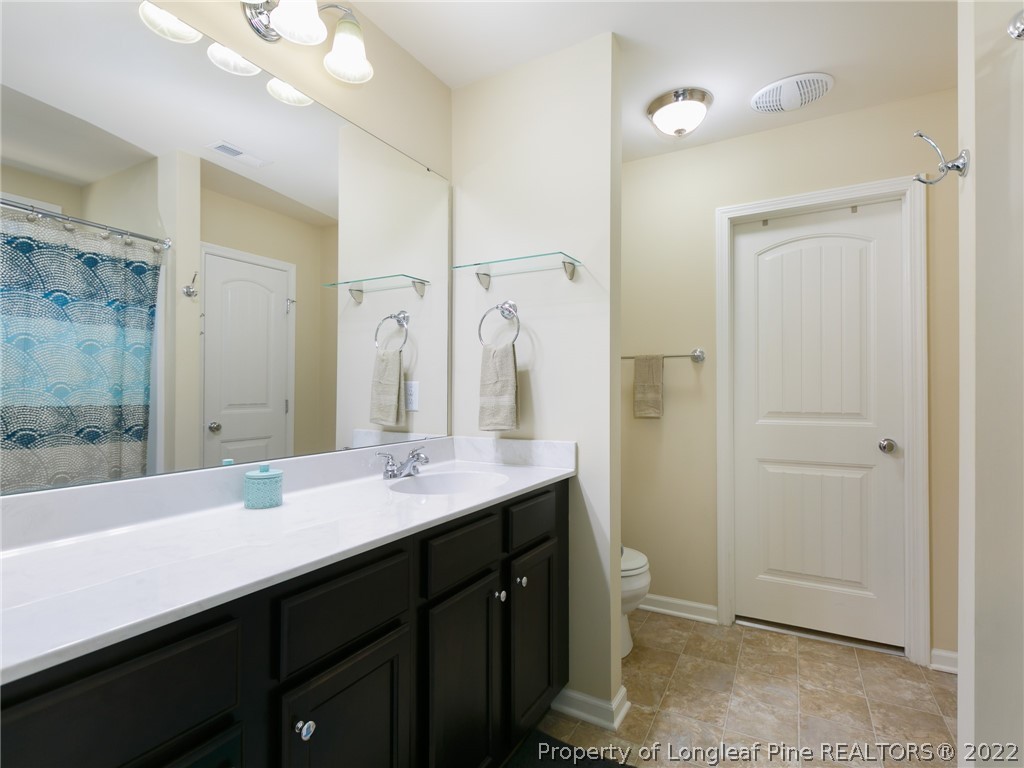 10 Rockingham Street Spring Lake, NC 28390 - Photo 23 of 33 a bathroom with a double vanity sink mirror and toilet