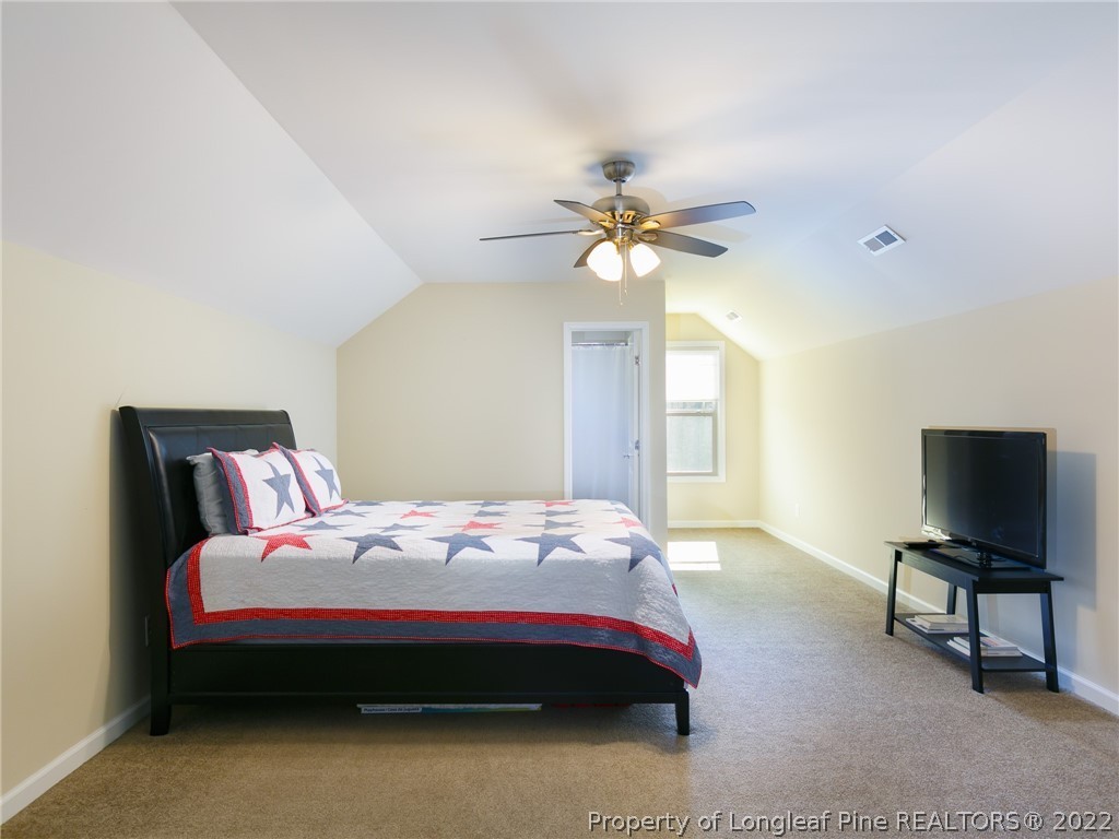10 Rockingham Street Spring Lake, NC 28390 - Photo 25 of 33 a bedroom with a bed and a chandelier