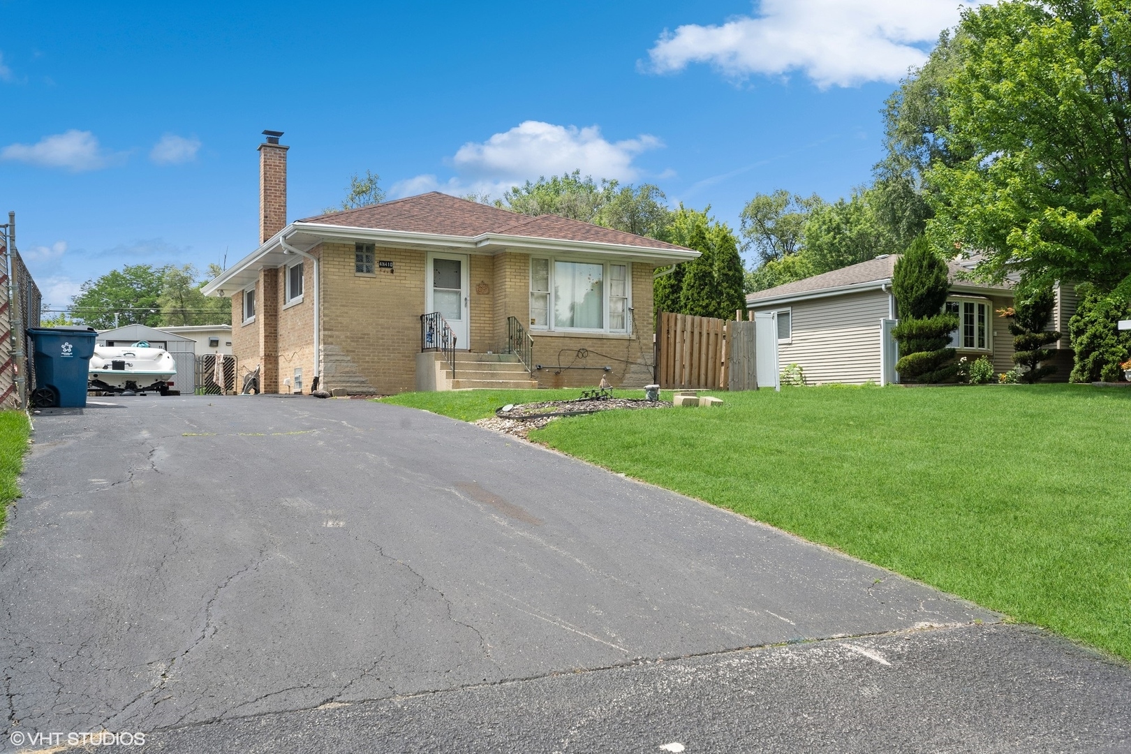 a front view of a house with a garden and plants
