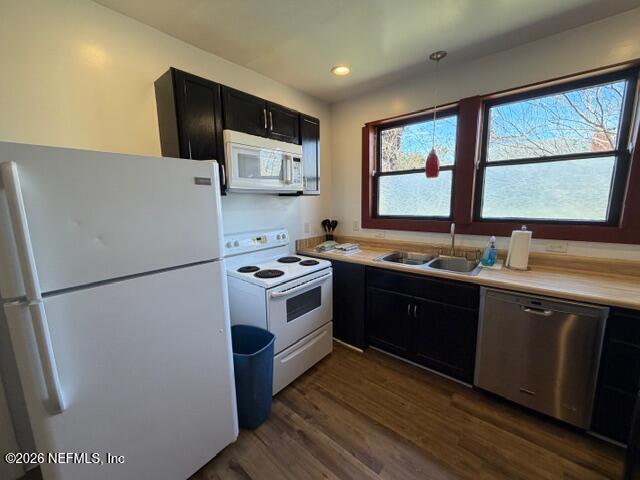 2670 Post Street, Unit 3 Jacksonville, FL 32204 - Photo 6 of 21 a kitchen with stainless steel appliances a refrigerator sink and wooden cabinets