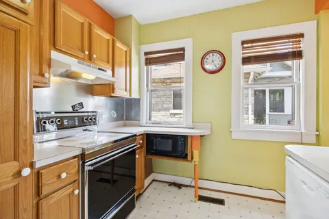 a kitchen with a stove a refrigerator and a sink