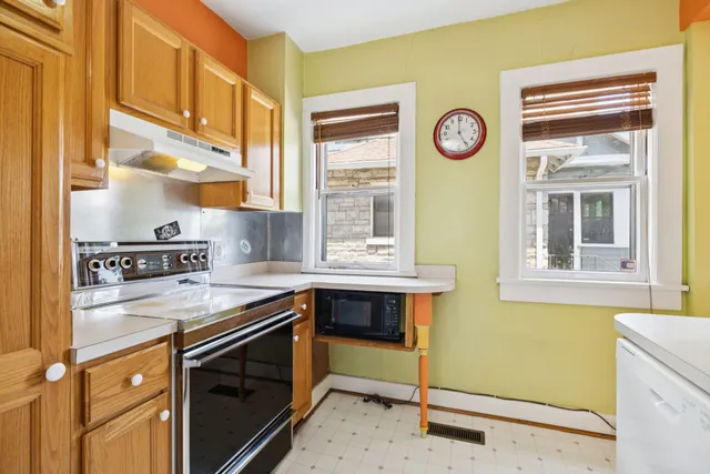 a kitchen with a stove a refrigerator and a sink