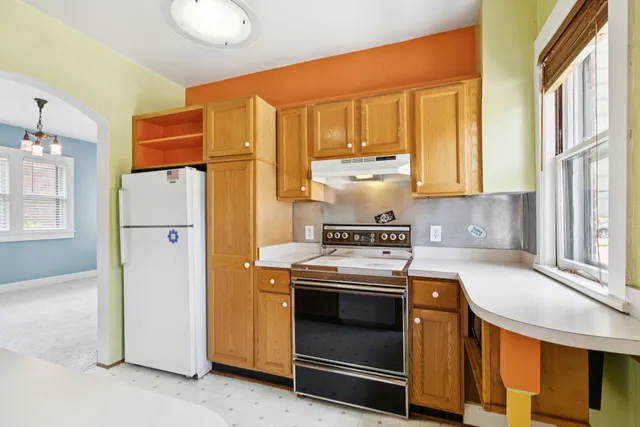 a kitchen with a sink a refrigerator and cabinets