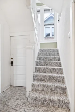 a view of a hallway with wooden floor and entryway