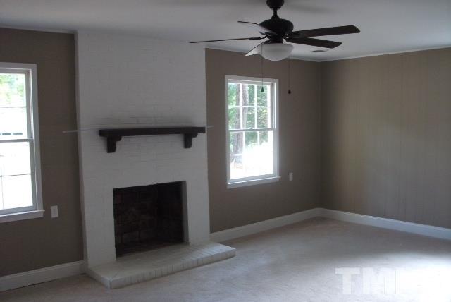 1325 Sedwick Road Durham, NC 27713 - Photo 11 of 16 an empty room with windows and fireplace