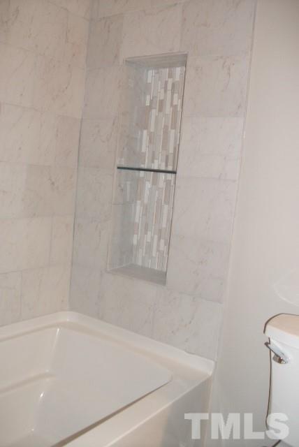 1325 Sedwick Road Durham, NC 27713 - Photo 13 of 16 a bathroom with a bathtub