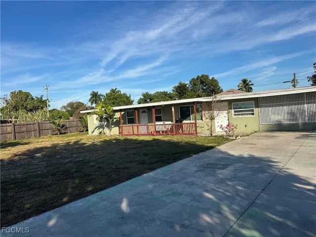 a view of house with outdoor space and swimming pool