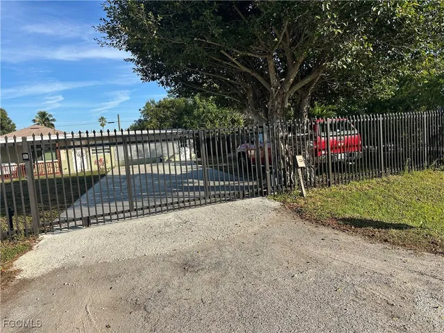 a view of street with wooden fence