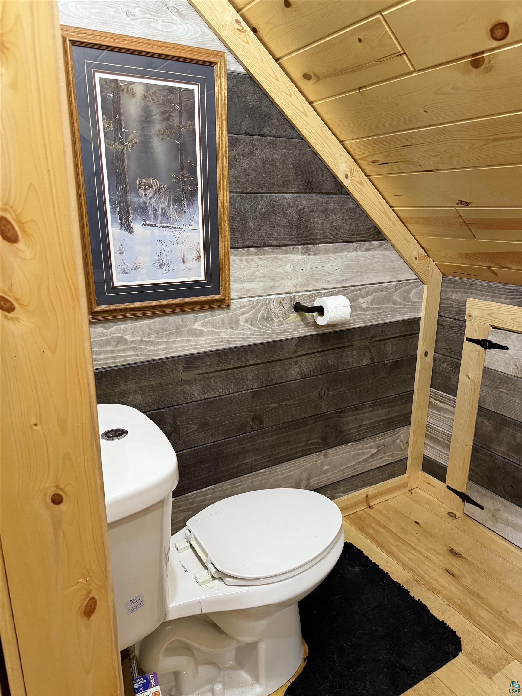 37590 Degerstrom Road Askov, MN 55704 - Photo 28 of 53 Bathroom featuring wood-finish flooring, plank wall paneling, and a sloped wood-paneled ceiling