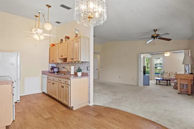 a view of a kitchen with furniture and chandelier